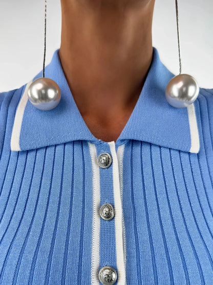 Close-up of the Celeste Midi Dress by Lauven, featuring a ribbed knit texture and sky blue color with pearl earrings.