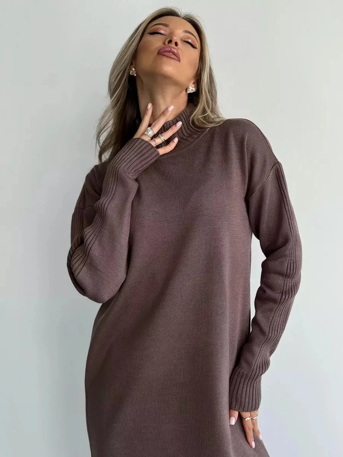 Noirra Midi Dress from Lauven, showcasing a model in a cocoa brown knit with a high-neck collar and relaxed design.