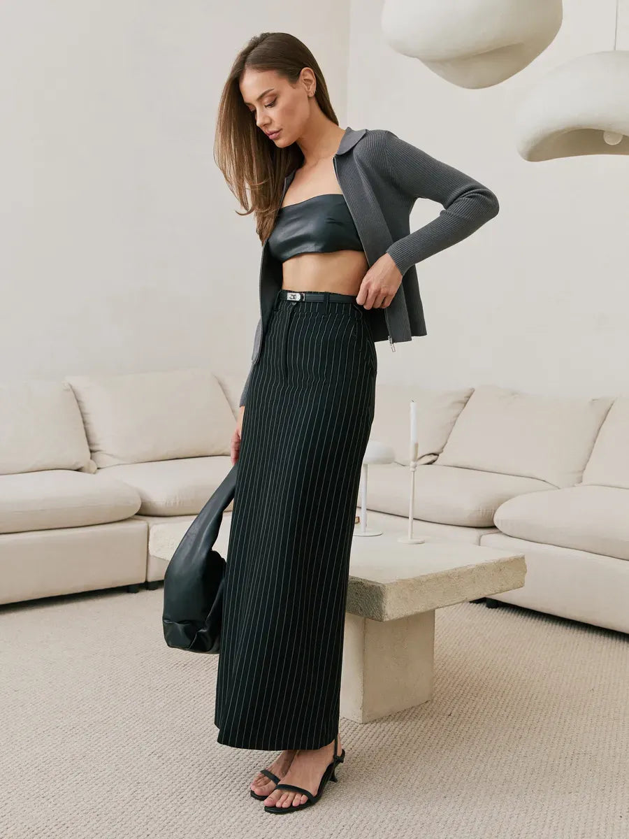 Orion Cardigan by Lauven in dark gray, styled with a black leather crop top and black pleated skirt.