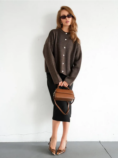 Model wearing Cocoa Cardigan in warm brown knit with button closure and stylish accessories.
