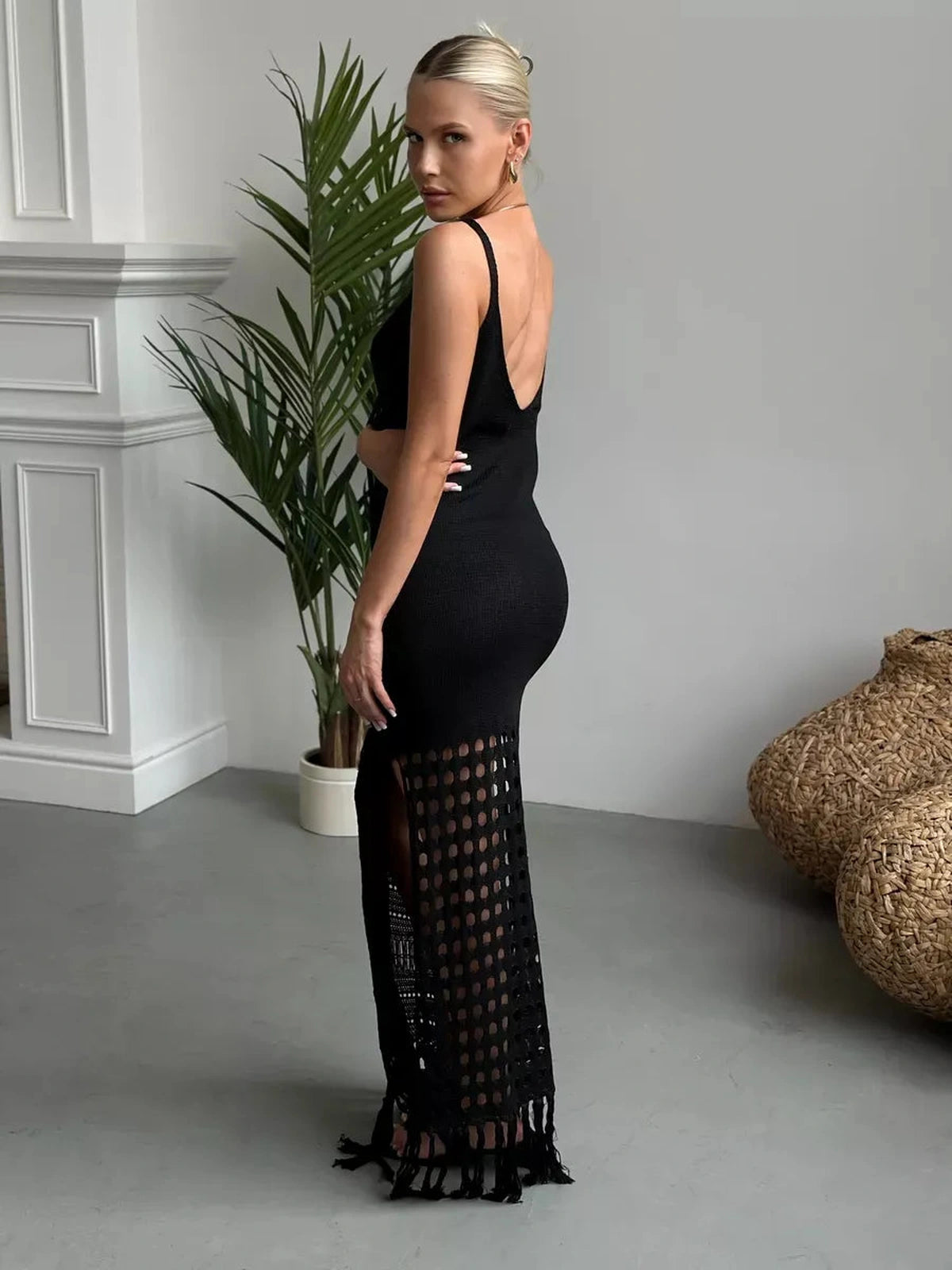 Model wearing Vespera Maxi Dress by Lauven featuring a dramatic side slit and fringe hem detail.