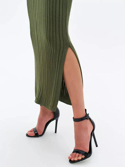 Olivea Midi Dress by Lauven showcases ribbed texture and side slit in khaki green, paired with stylish black heels.