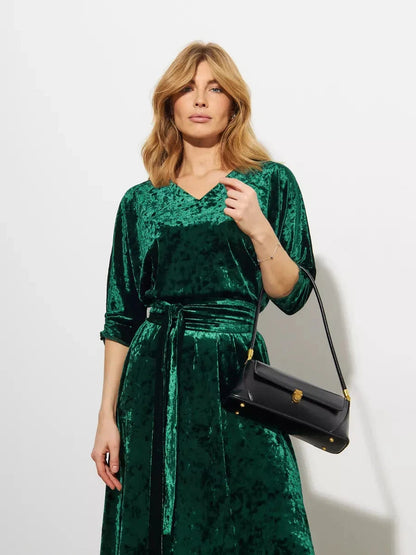 Emerelle Maxi Dress by Lauven worn by model, showcasing its emerald green velvet in a sophisticated A-line silhouette.