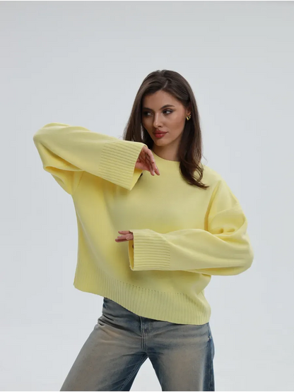 Model wearing the Solara Sweater by Lauven, a light yellow oversized knit with cropped elegance.