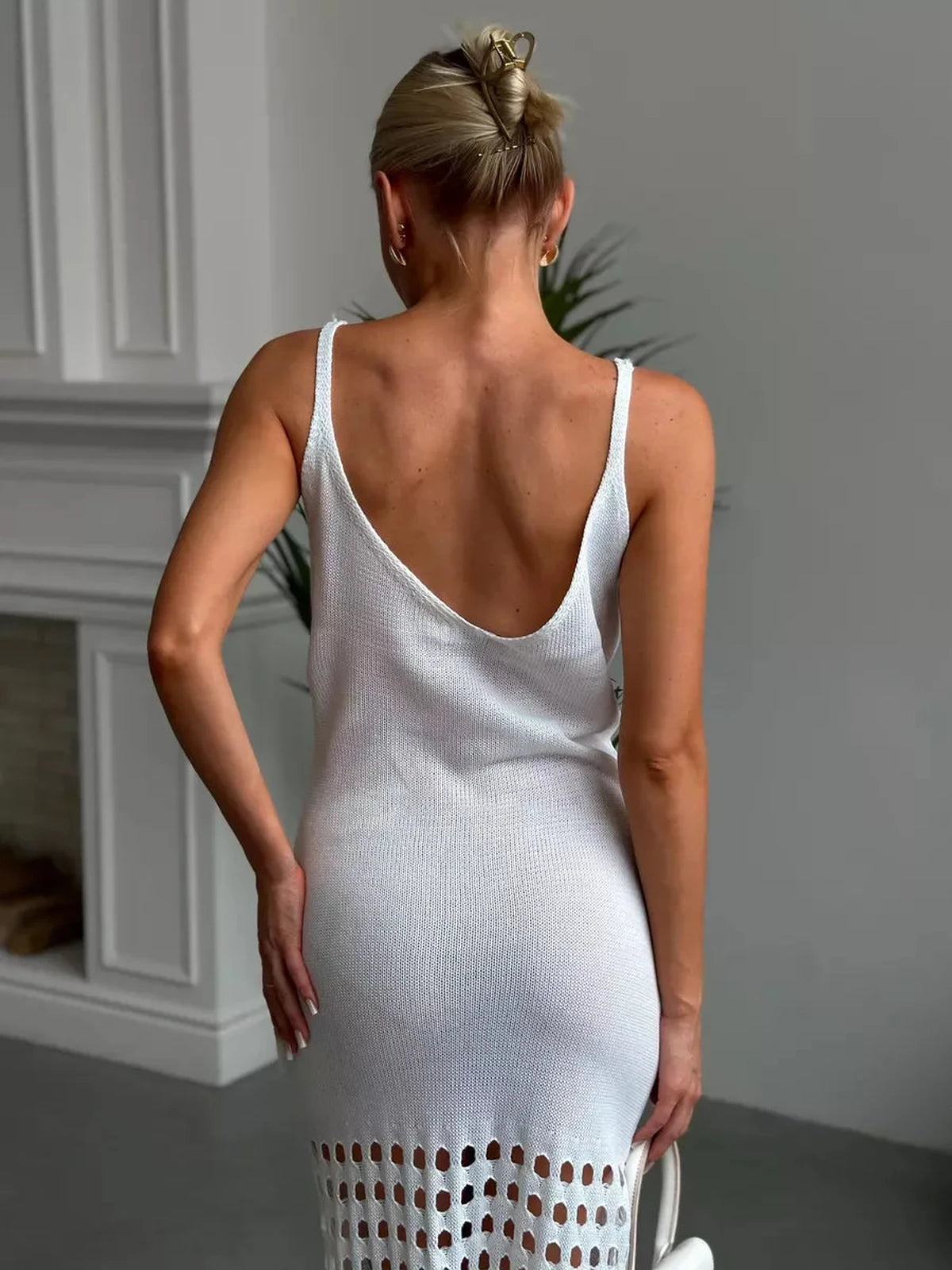 Back view of a woman wearing the Solara Maxi Dress by Lauven, featuring airy knit detailing and fringe hem.