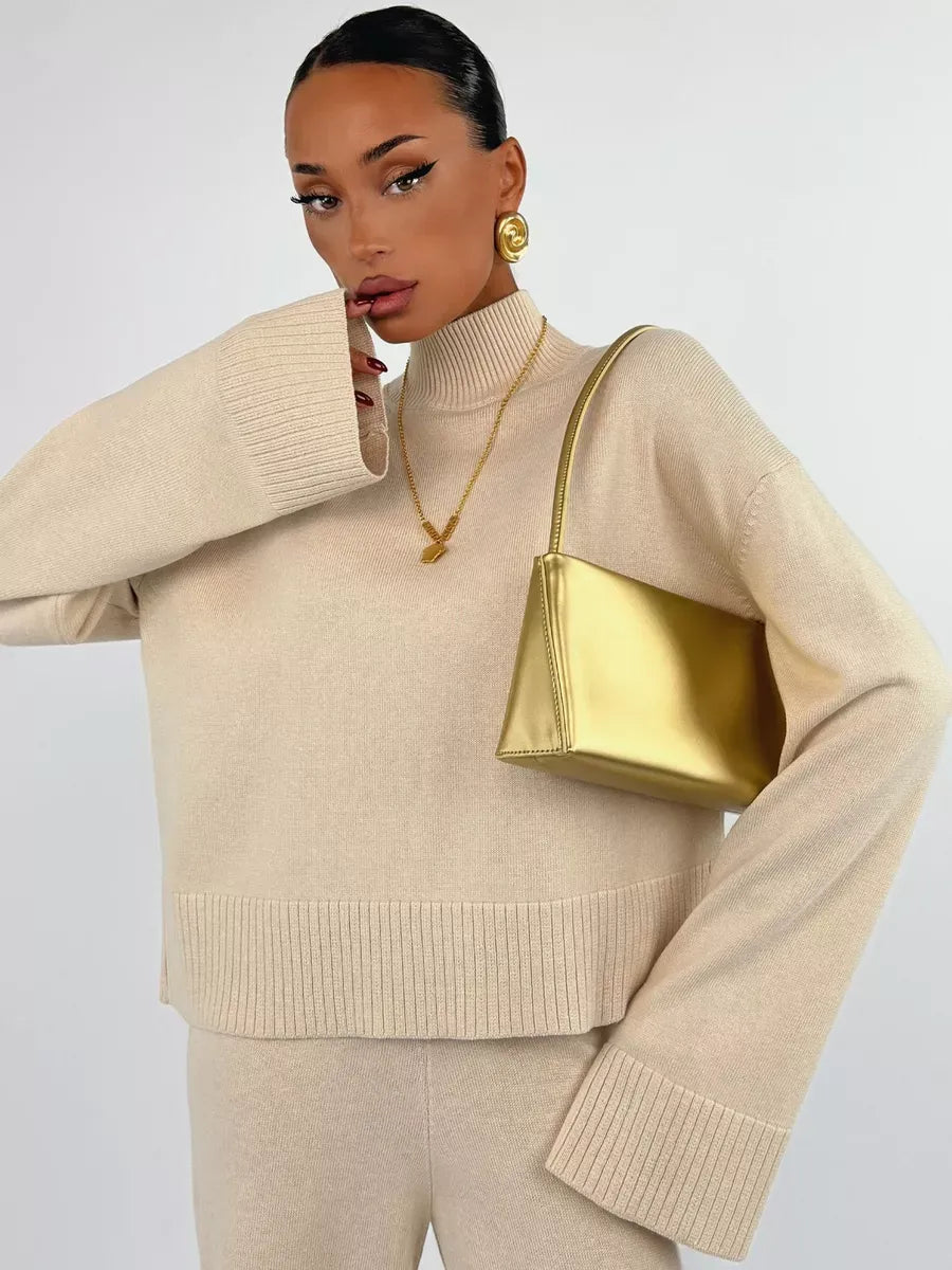 Eterna Sweater by Lauven in light beige, oversized knitwear styled with gold accessories.