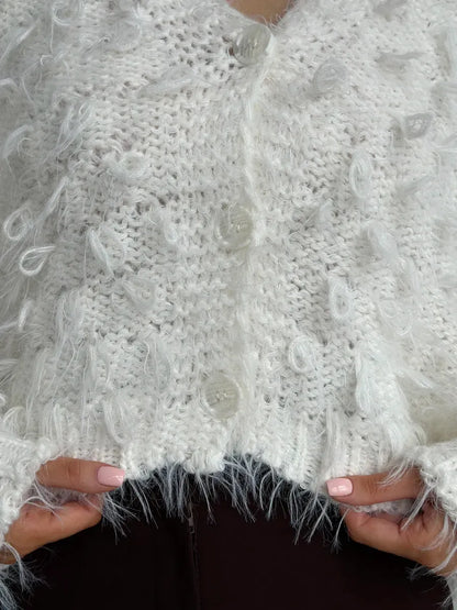 Ivory Cardigan by Lauven featuring cropped oversized bouclé knit with playful feathered fringe details.
