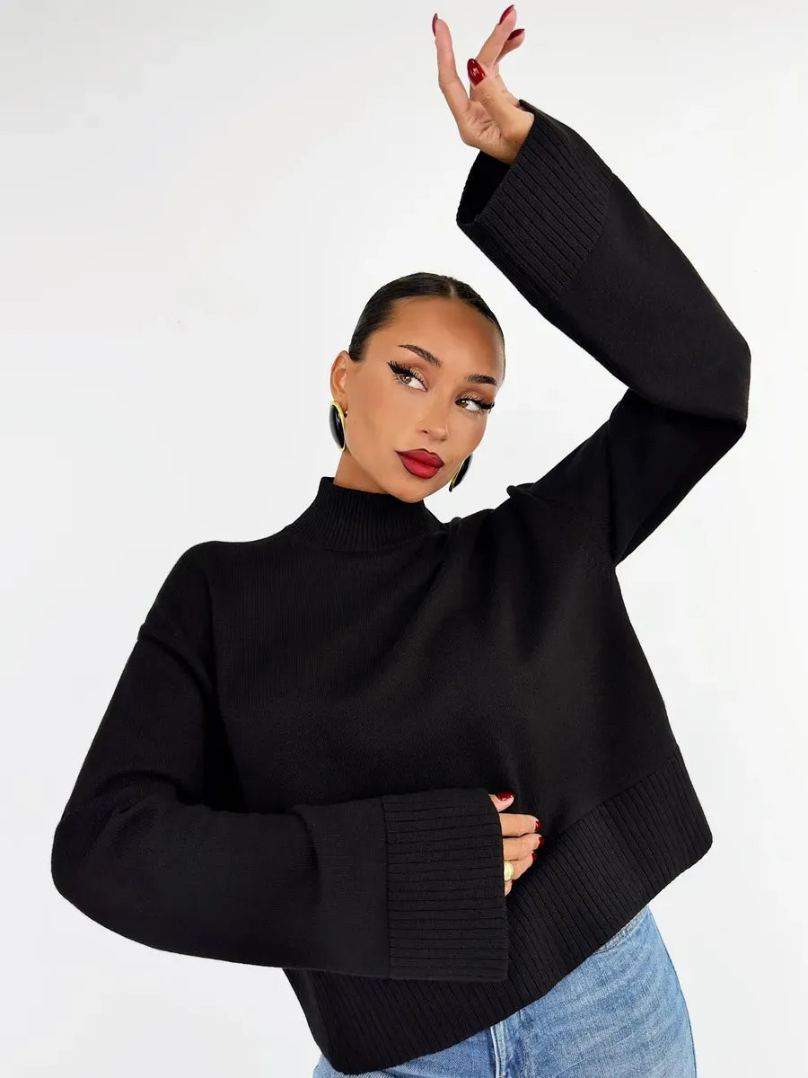 Woman wearing the Noir Sweater by Lauven, an oversized black cotton blend knit sweater.