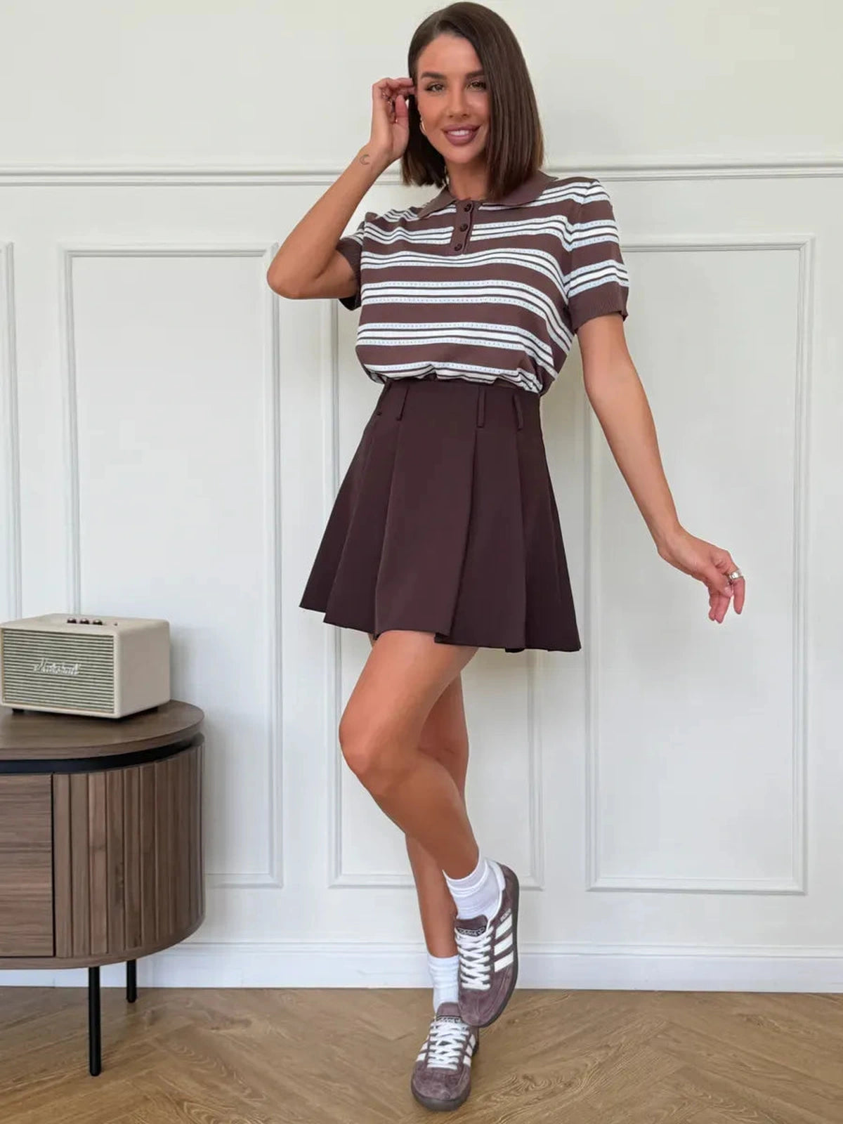 Verona Mini Skirt by Lauven - Chocolate brown pleated A-line skirt paired with a striped shirt for a chic look.