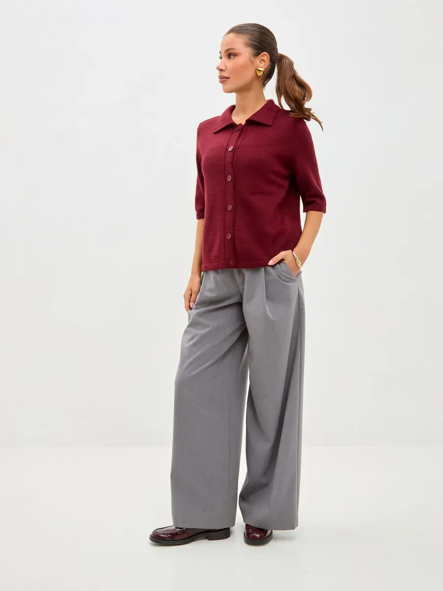 Mira Cardigan by Lauven in lightweight burgundy wool blend, styled with gray wide-leg trousers.