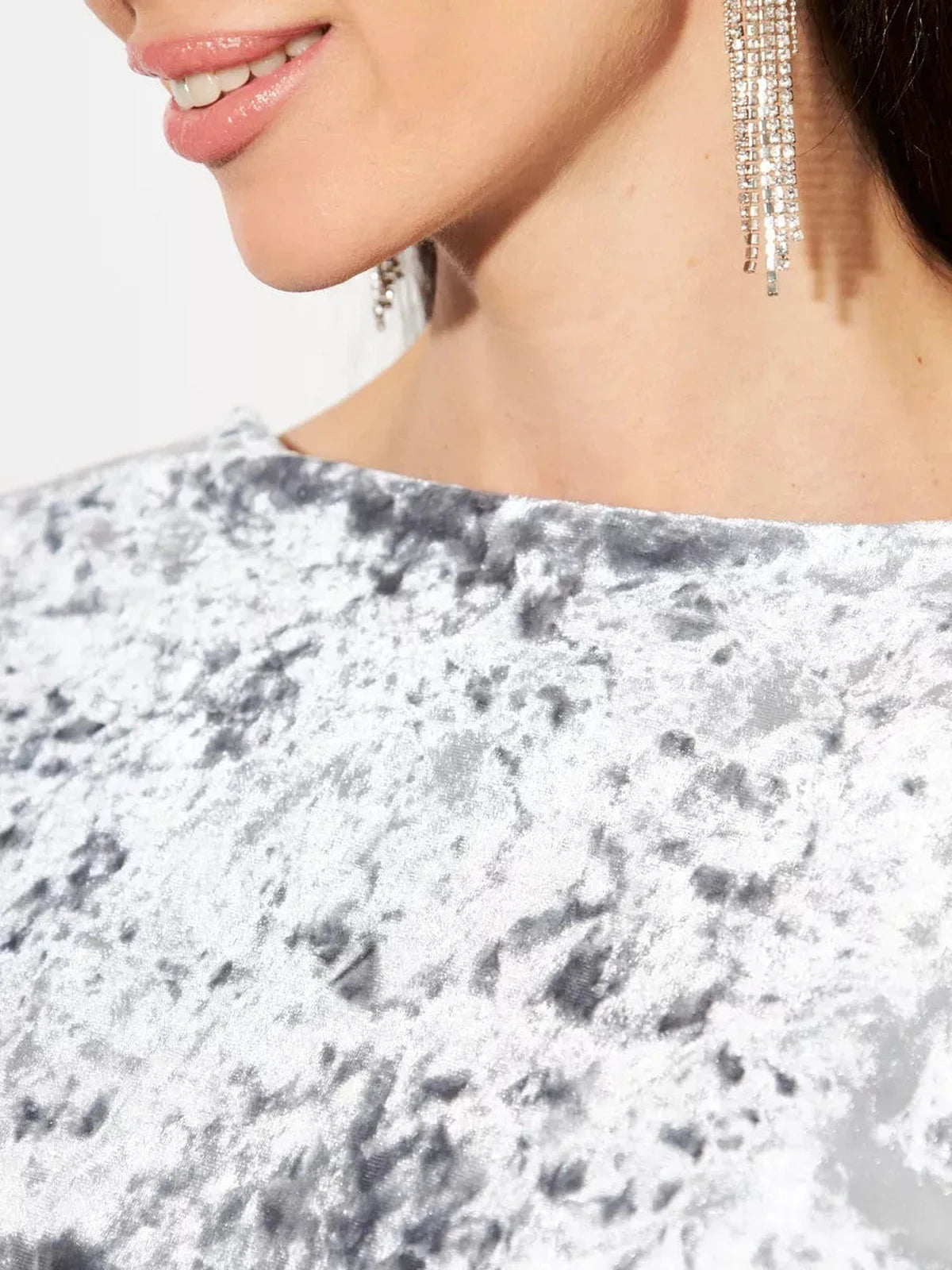 Close-up of Selene Maxi Dress in silver velvet, showcasing its texture and elegant earrings for a luxe look by Lauven.