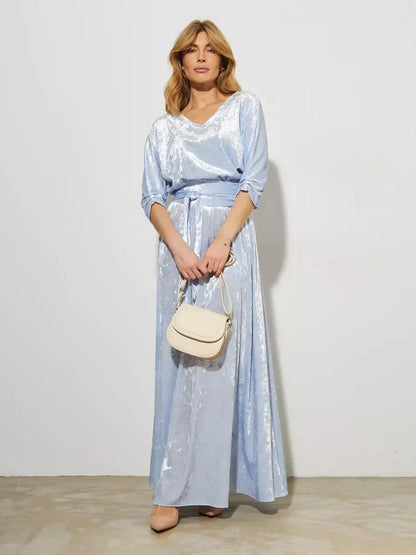 Lunara Maxi Dress by Lauven in light blue velvet, showcasing a woman holding a stylish bag, perfect for evening occasions.