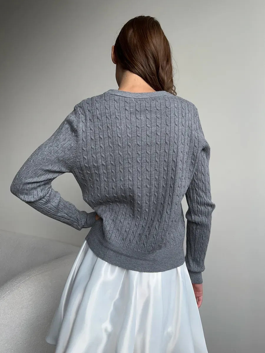 Back view of a woman wearing the Sterling Cardigan in lightweight grey with cable knit detail by Lauven.