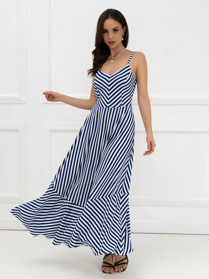 Model wearing the Marina Stripe Maxi Dress featuring bold stripes and flowing silhouette, perfect for summer outings.