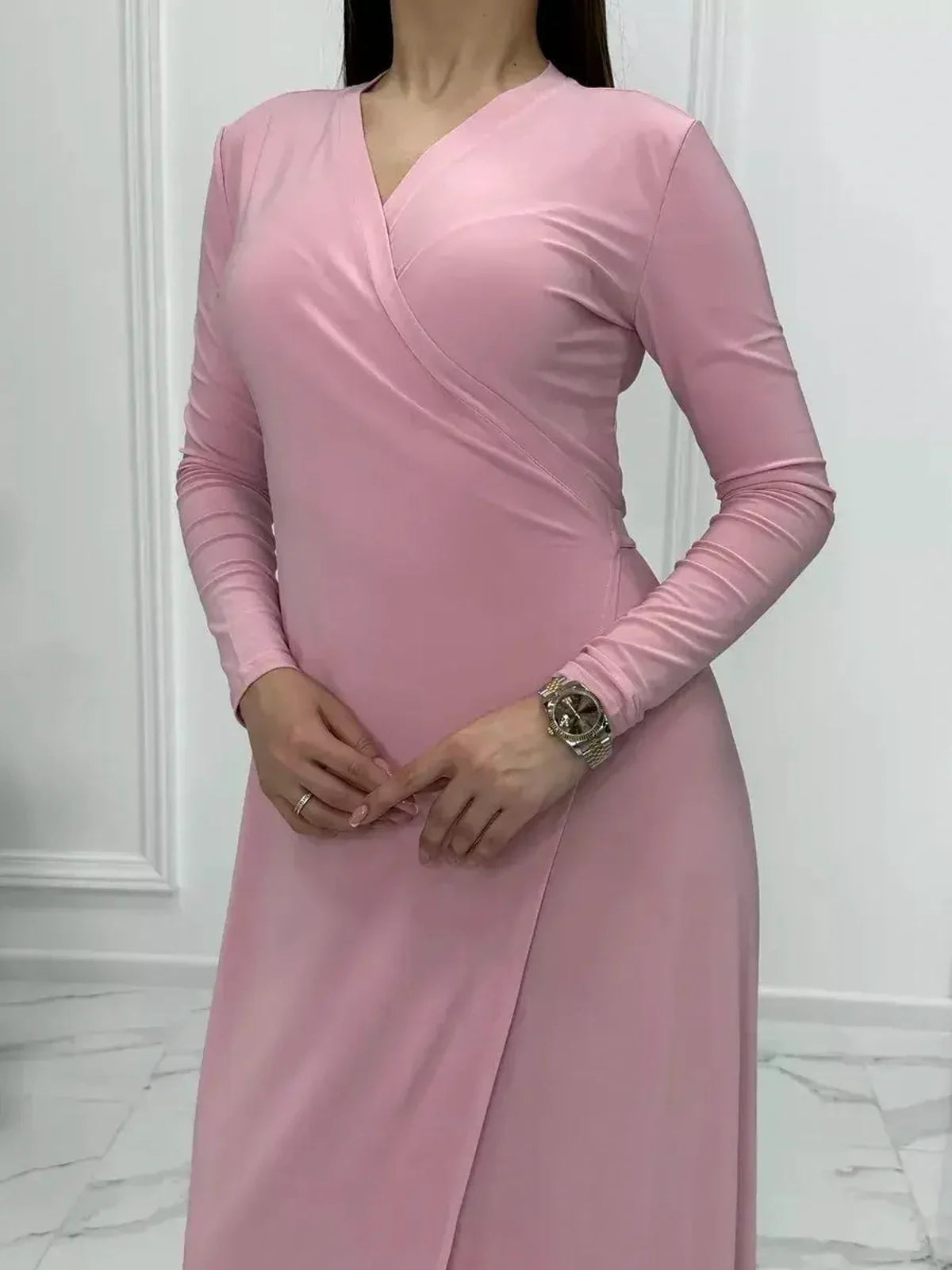 Elegant powder pink Eclipse Maxi Dress featuring a long sleeve wrap silhouette and flattering V-neckline.