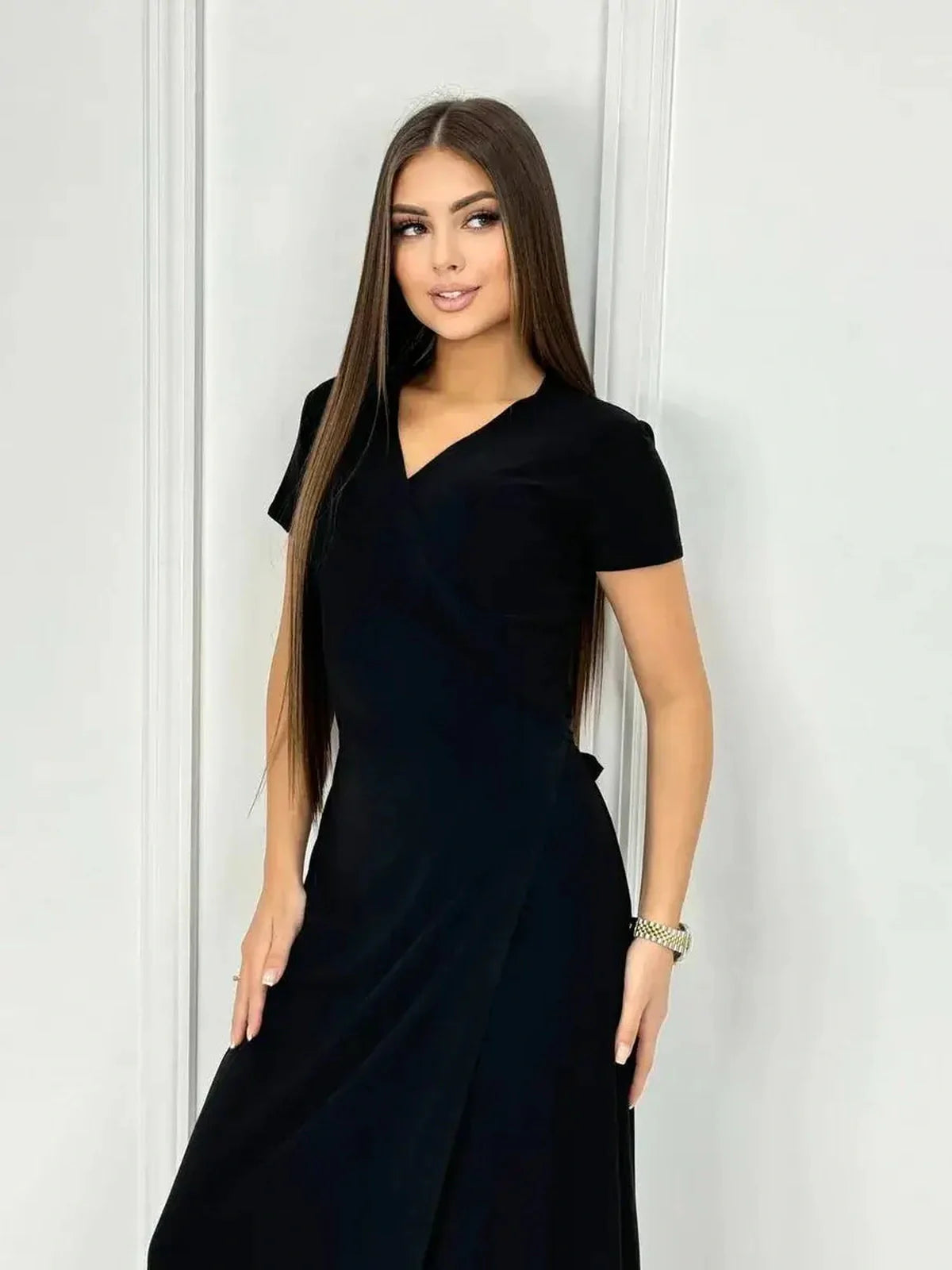 Model wearing the Obsidian Grace Maxi Dress, showcasing its elegant wrap silhouette and timeless black hue.