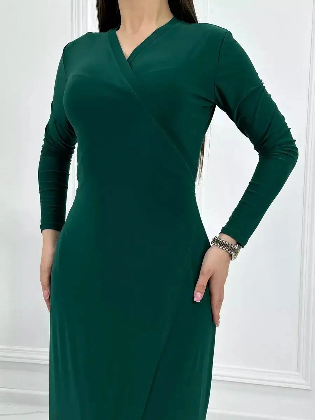 Elegant long-sleeve Emerald Allure Maxi Dress showcasing a flattering wrap silhouette and rich emerald color.