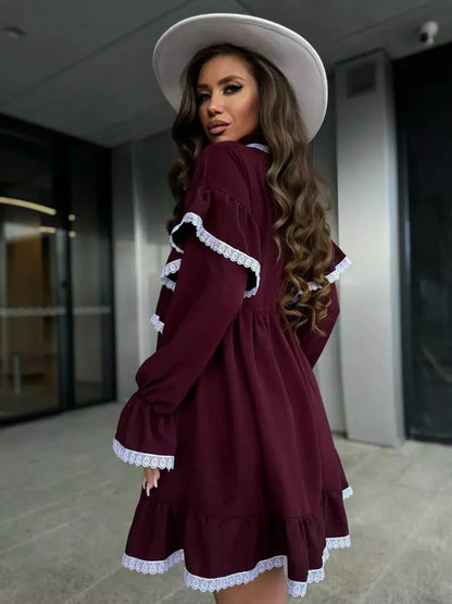 Model wearing the Marina Mini Dress by Lauven, showcasing delicate lace and ruffle details in burgundy.