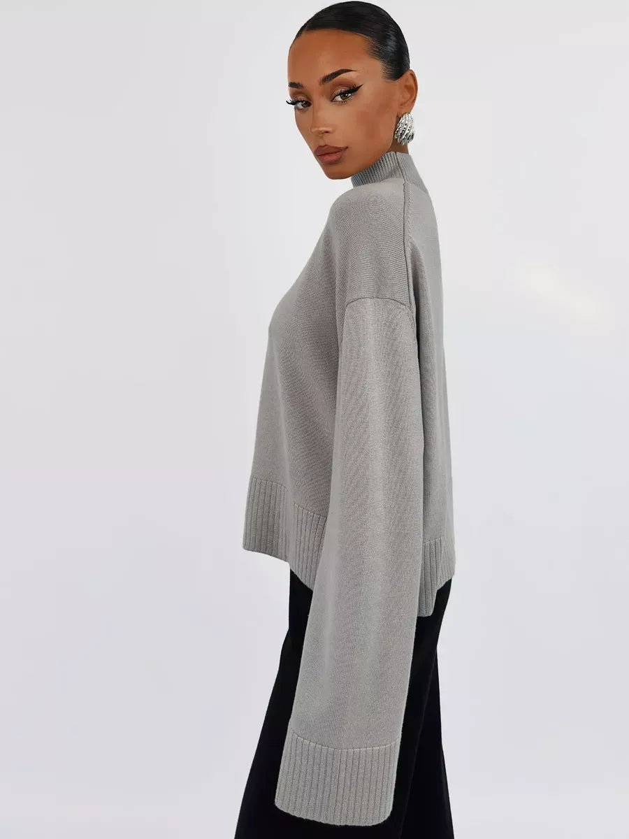 Elegant model showcasing the Arden Sweater by Lauven in gray, featuring an oversized cotton blend knit design.
