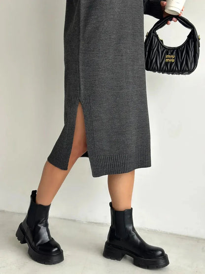 Asteria Midi Dress by Lauven featuring a side slit, paired with black ankle boots and a stylish handbag.