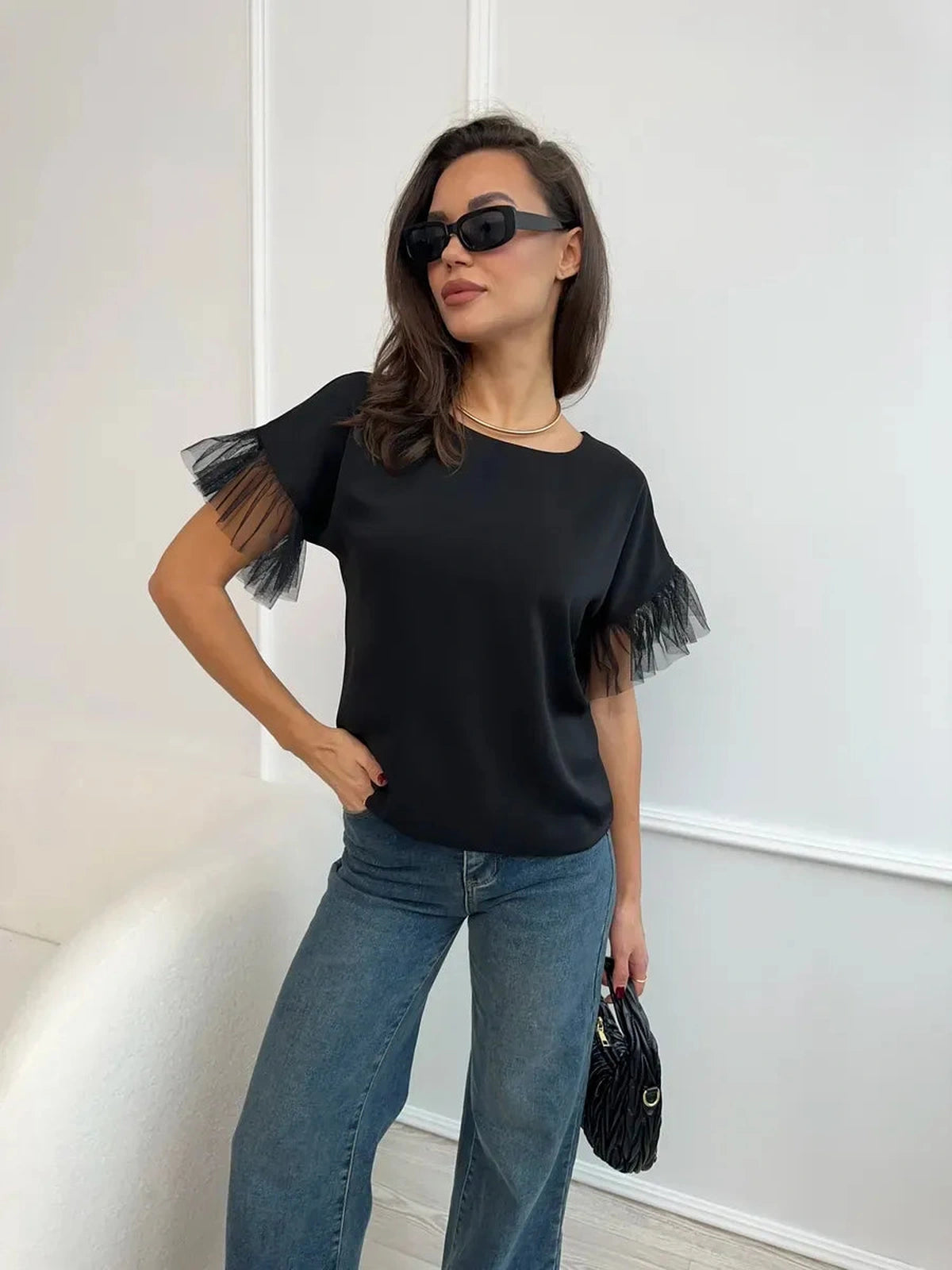 Noiré Blouse by Lauven, elegant black short sleeve blouse with tulle ruffle detail for modern femininity.