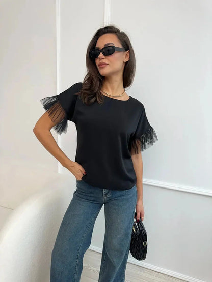 Noiré Blouse by Lauven, elegant black short sleeve blouse with tulle ruffle detail for modern femininity.