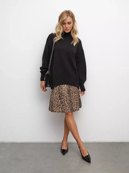 Model wearing Nyra Sweater in black with leopard print skirt and black heels, showcasing Lauven brand style.