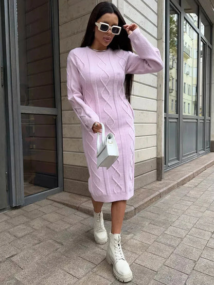 Model wearing the Luna Midi Dress by Lauven, a textured knit sweater dress in soft pink, styled with white boots.