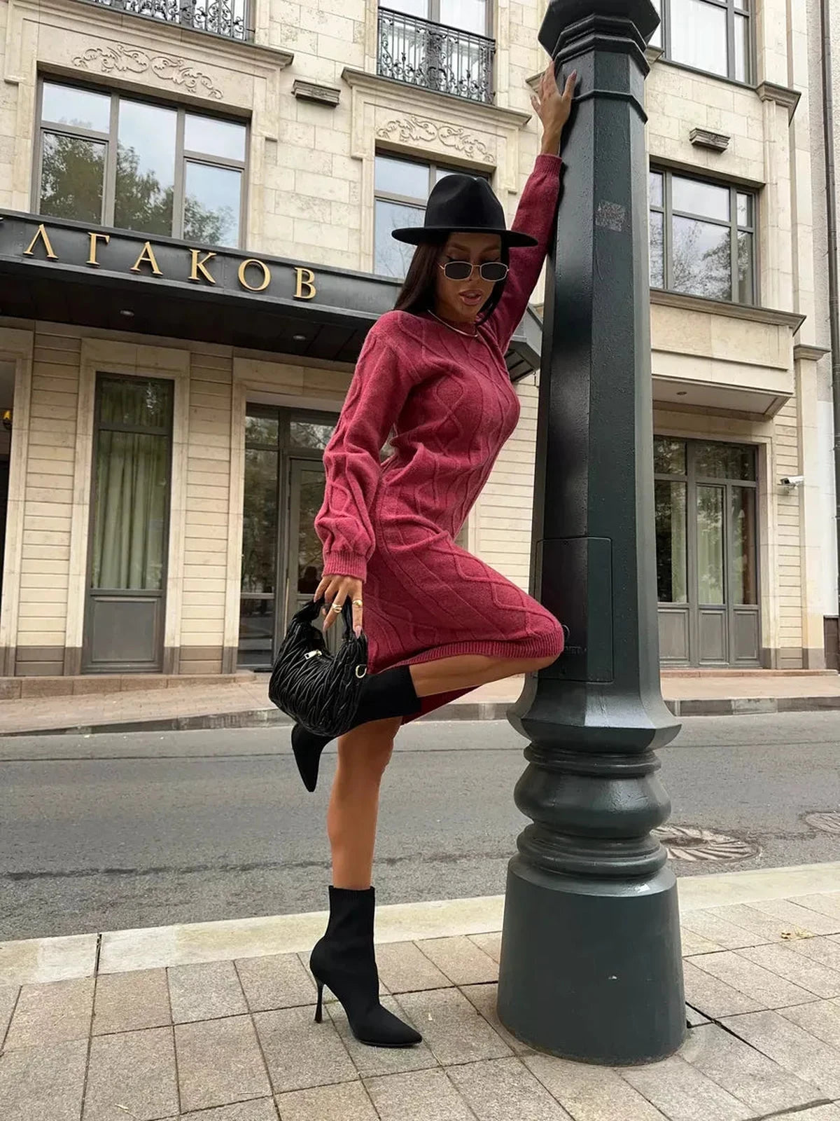 Berry Midi Dress worn elegantly outdoors, showcasing the textured knit design and stylish accessories by Lauven.