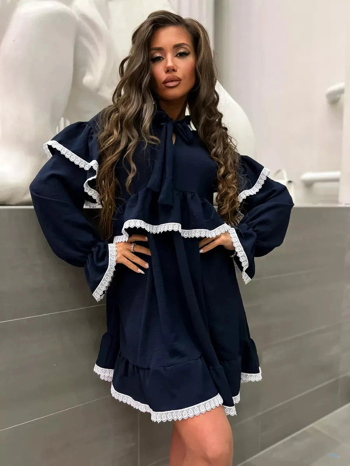 Celeste Mini Dress by Lauven, featuring graceful ruffles and lace accents in dark navy, perfect for elegant occasions.