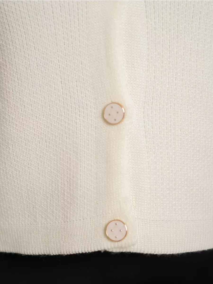 Ivory Cardigan by Lauven featuring decorative buttons in a creamy white knit fabric.