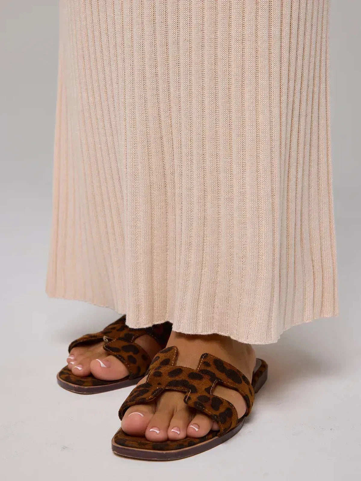 Rosette Maxi Dress featuring elegant beige ribbed knit fabric and stylish leopard print sandals.