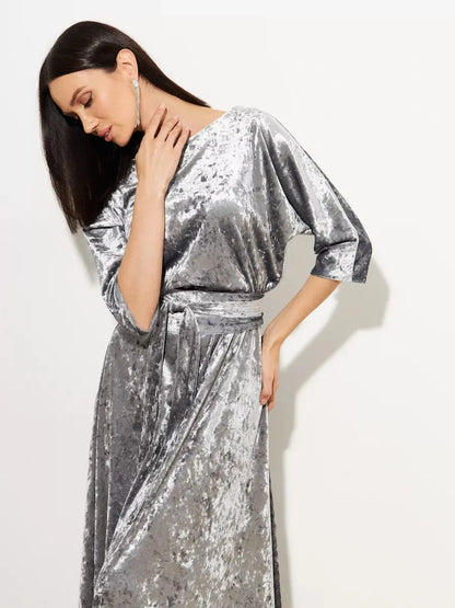 Elegant model wearing the Selene Maxi Dress by Lauven in silver velvet, showcasing its luxurious and flowing design.