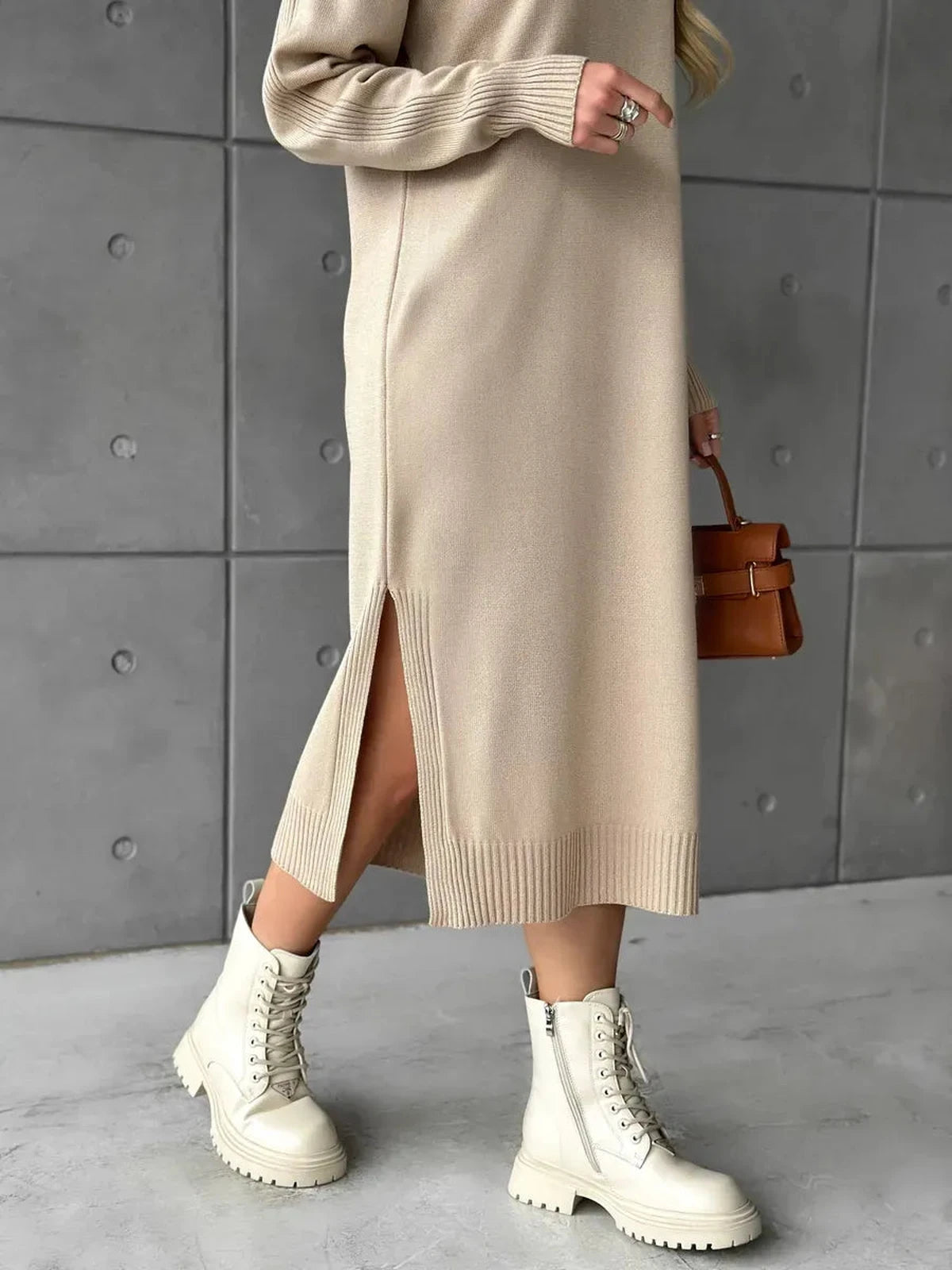 Seren Midi Dress by Lauven featuring a side slit, beige knit fabric, styled with chunky white boots.