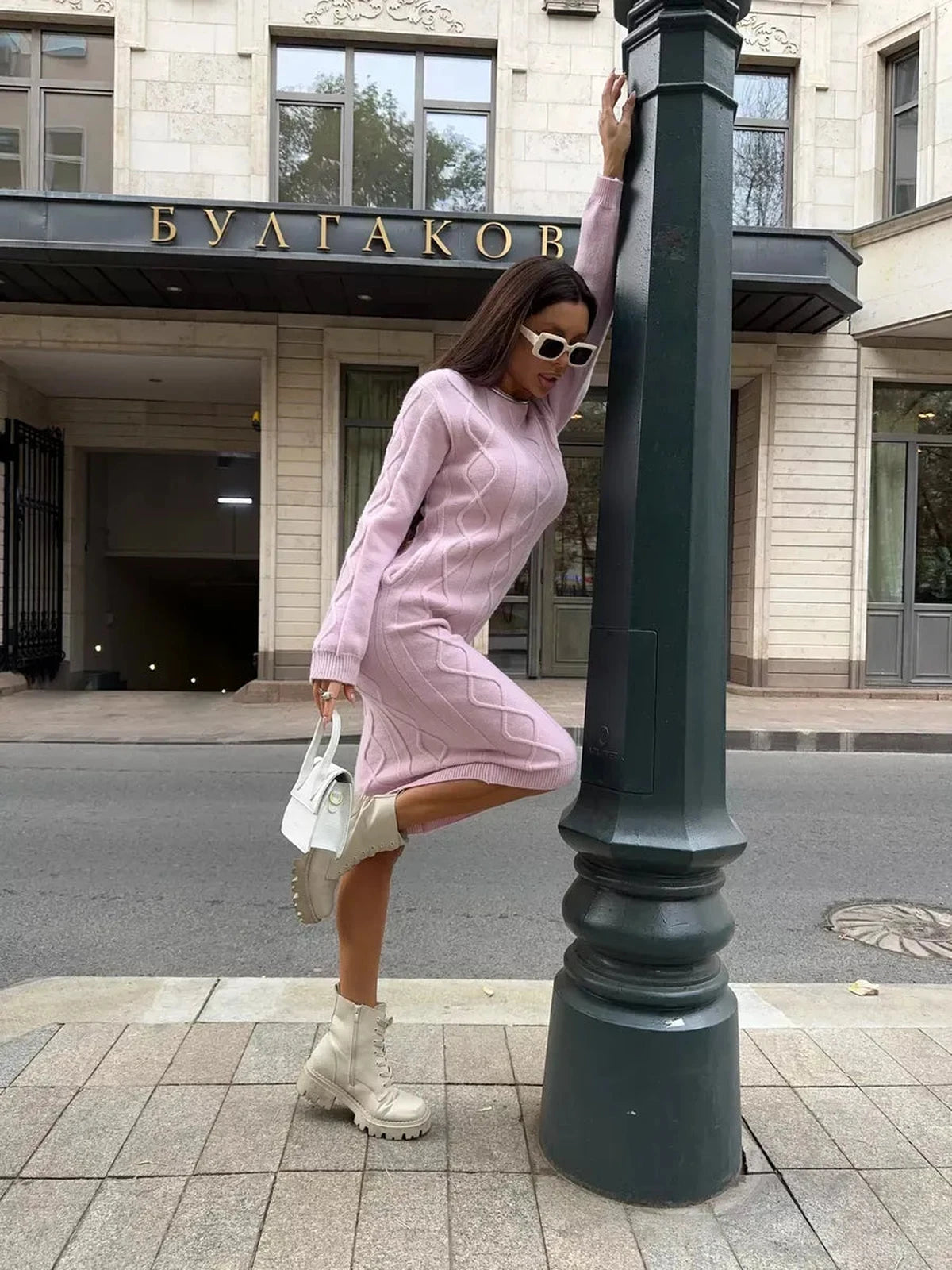 Luna Midi Dress by Lauven, a textured knit sweater dress in soft pink, showcased outdoors.