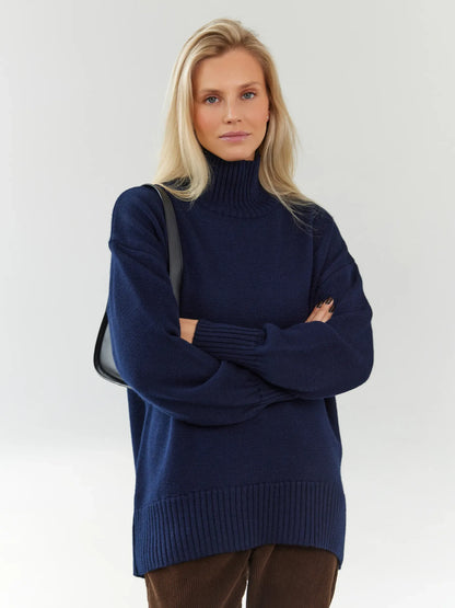 Celeste Sweater by Lauven: Oversized wool knit turtleneck in dark navy worn by a woman.