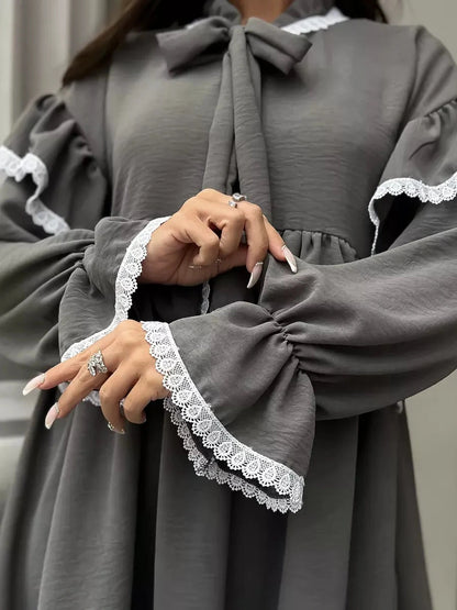 Luna Mini Dress by Lauven featuring elegant ruffled design and lace trim details on sleeves.