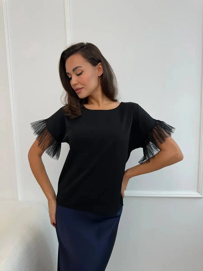 Noiré Blouse by Lauven - Elegant black blouse with tulle ruffle details, perfect for any occasion.