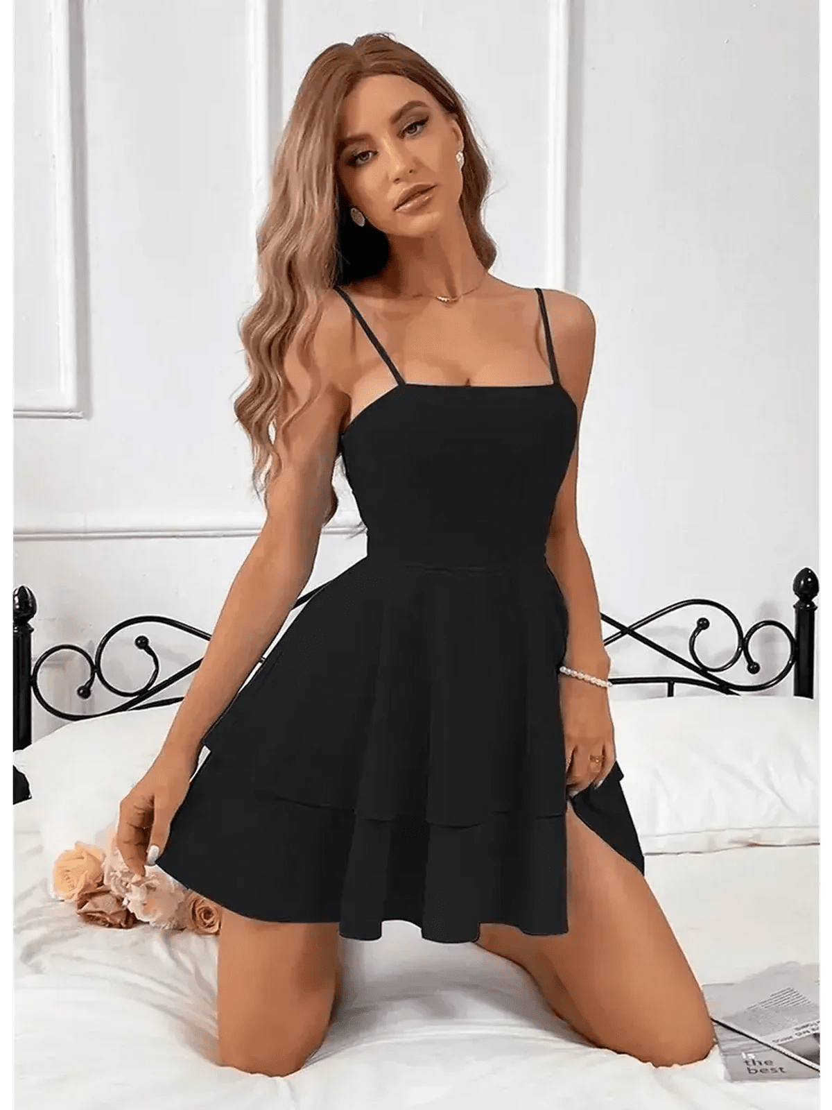 Noir Bloom Mini Dress in black, featuring a tiered flounce skirt and elegant slim straps, styled for a feminine look.