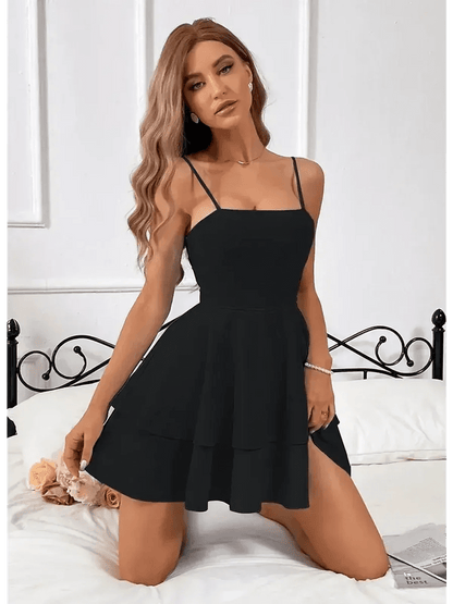 Noir Bloom Mini Dress in black, featuring a tiered flounce skirt and elegant slim straps, styled for a feminine look.