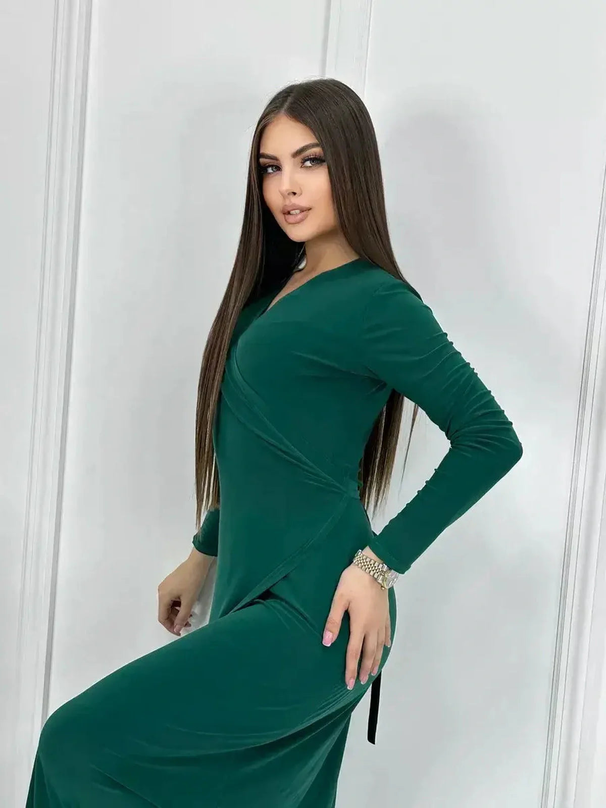 Model showcasing the elegant Emerald Allure Maxi Dress featuring a wrap silhouette and fluid drape.