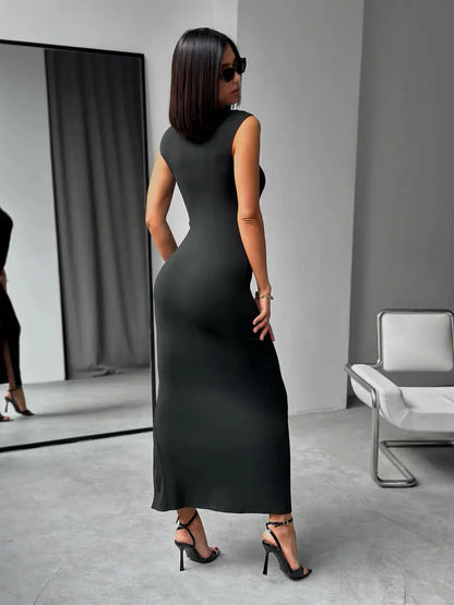 Model showcasing the Sculpted Charm Maxi Dress, a sleek black design with a body-hugging fit and square neckline.