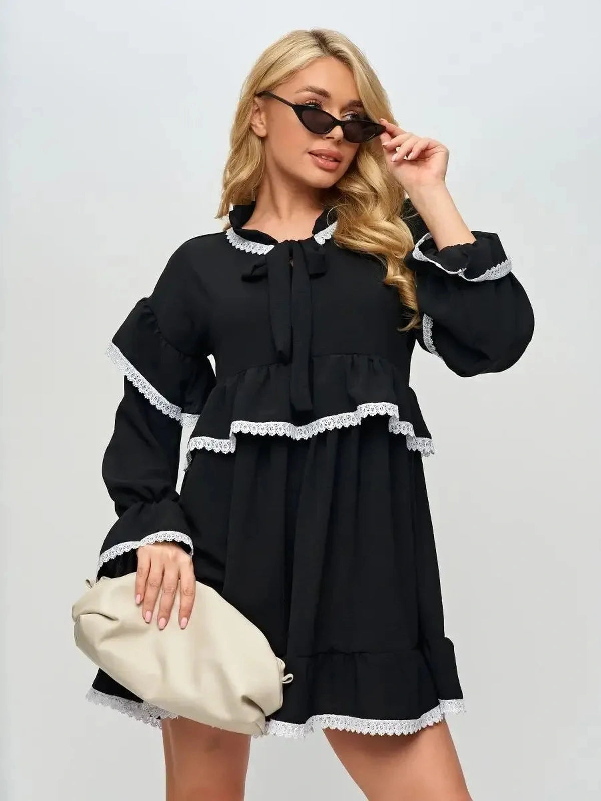 Noiré Mini Dress by Lauven, featuring elegant ruffles and delicate lace trim in a stylish black design for modern elegance.