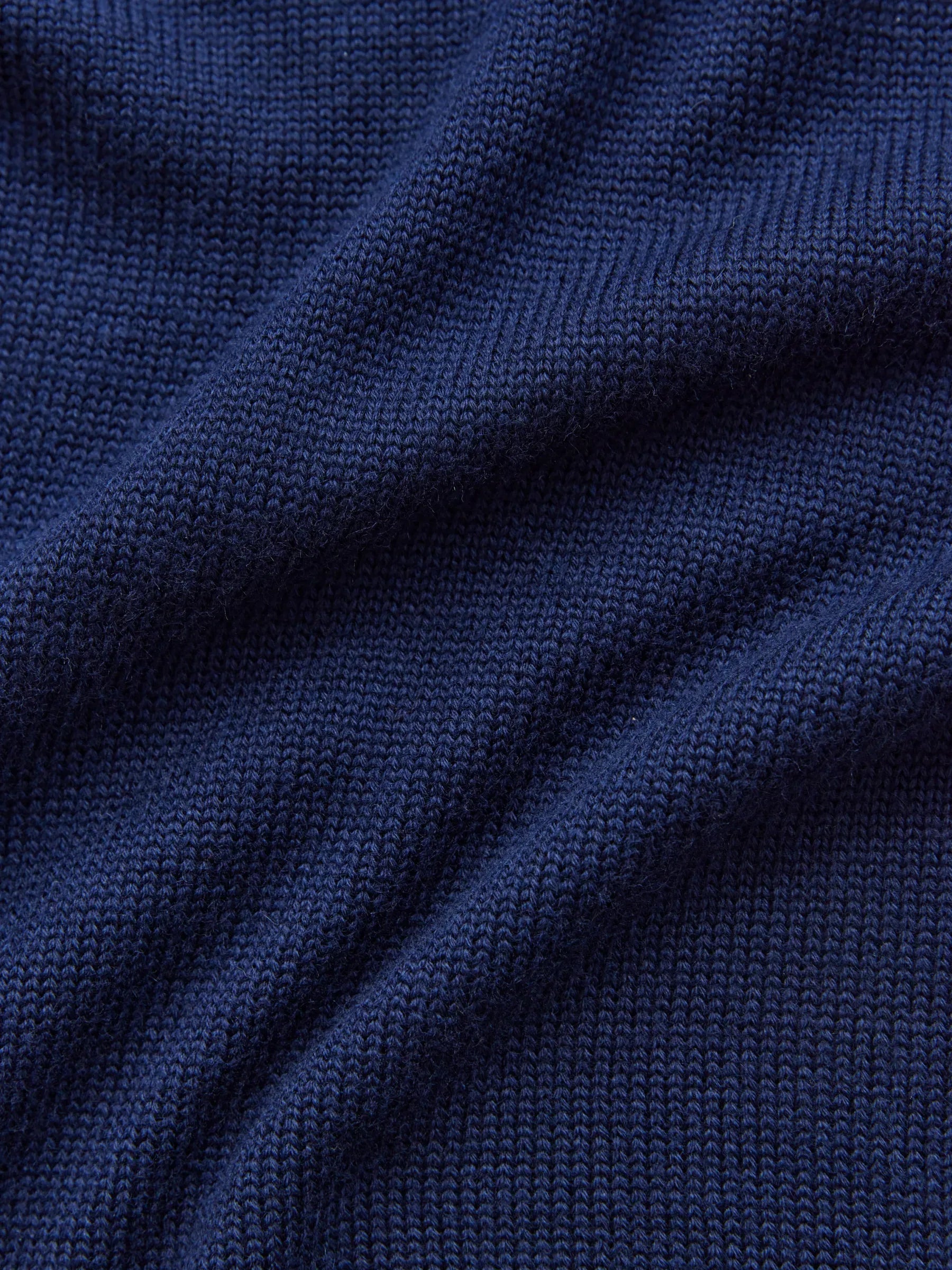 Deep navy knit fabric showcasing the texture of the Celeste Sweater by Lauven, a cozy oversized women’s wool knit.
