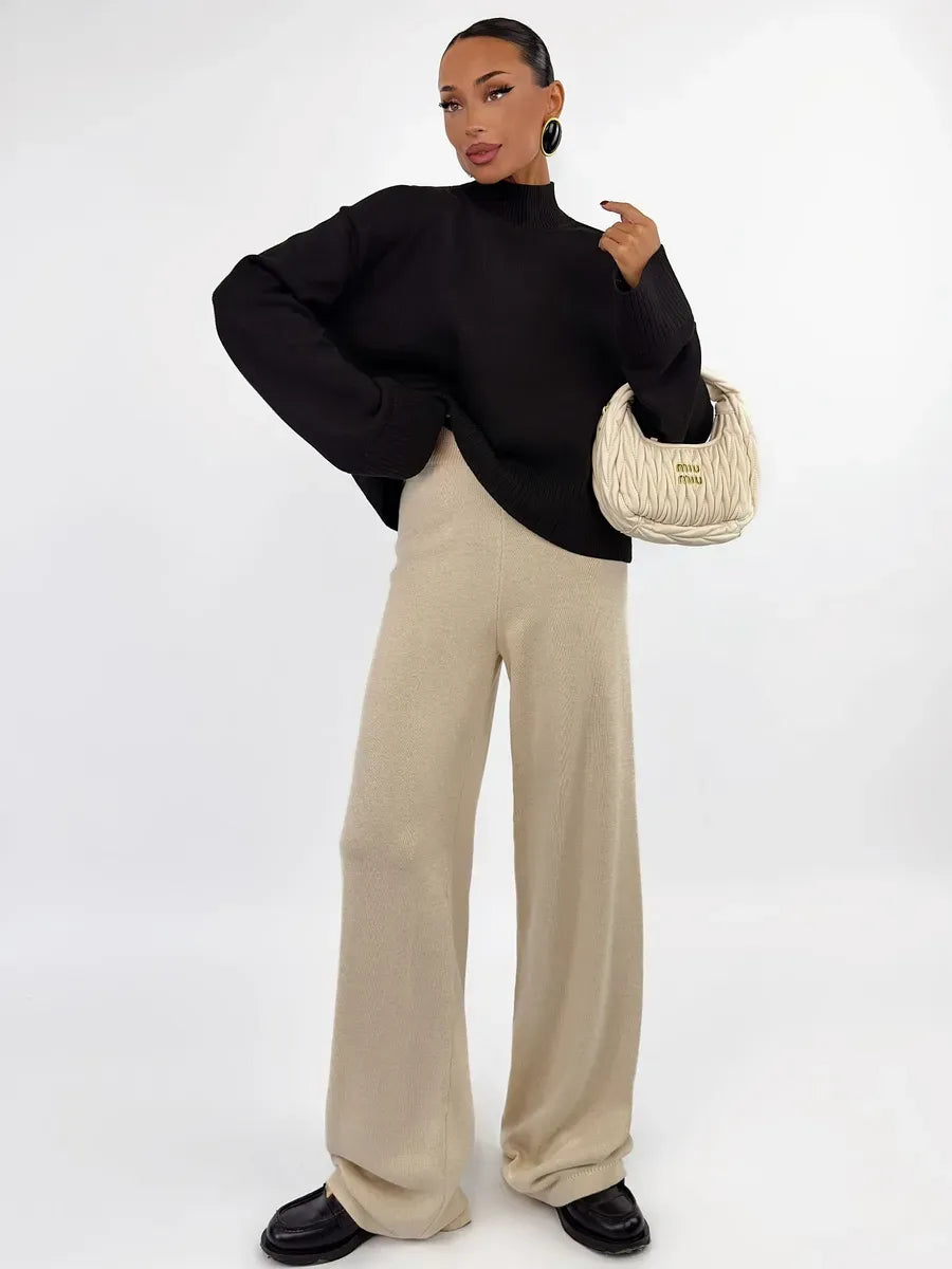 Model wearing a Noir Sweater paired with beige wide-leg pants, showcasing refined style by Lauven.