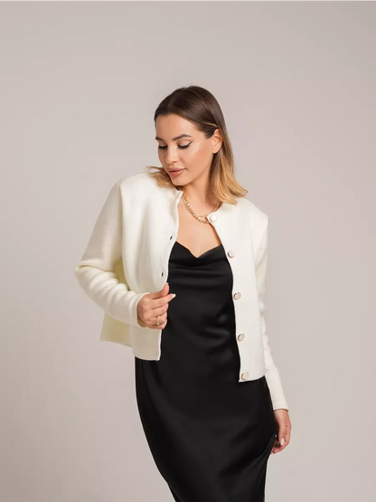 Ivory Cardigan by Lauven - Creamy white short knit with decorative buttons, styled elegantly with a black dress.