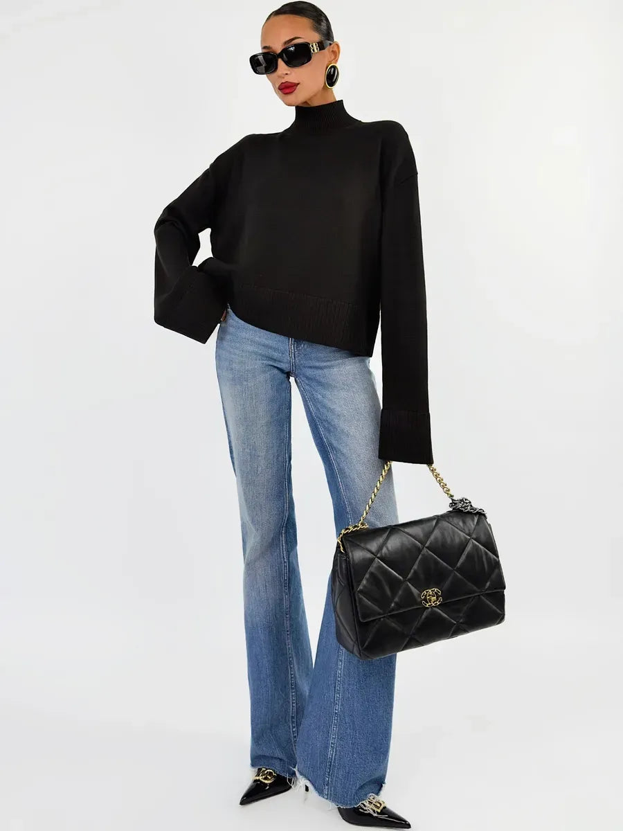 Noir Sweater by Lauven, oversized cotton blend knit in black, paired with stylish flared jeans and accessories.