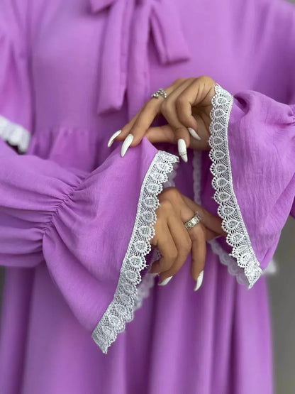 Violetta Mini Dress details showcasing delicate lace and flowing ruffles by Lauven, perfect for an elegant style.