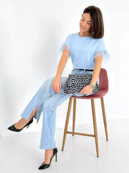 Celeste Blouse by Lauven - Light blue silky top with tulle details, styled with jeans and heels.
