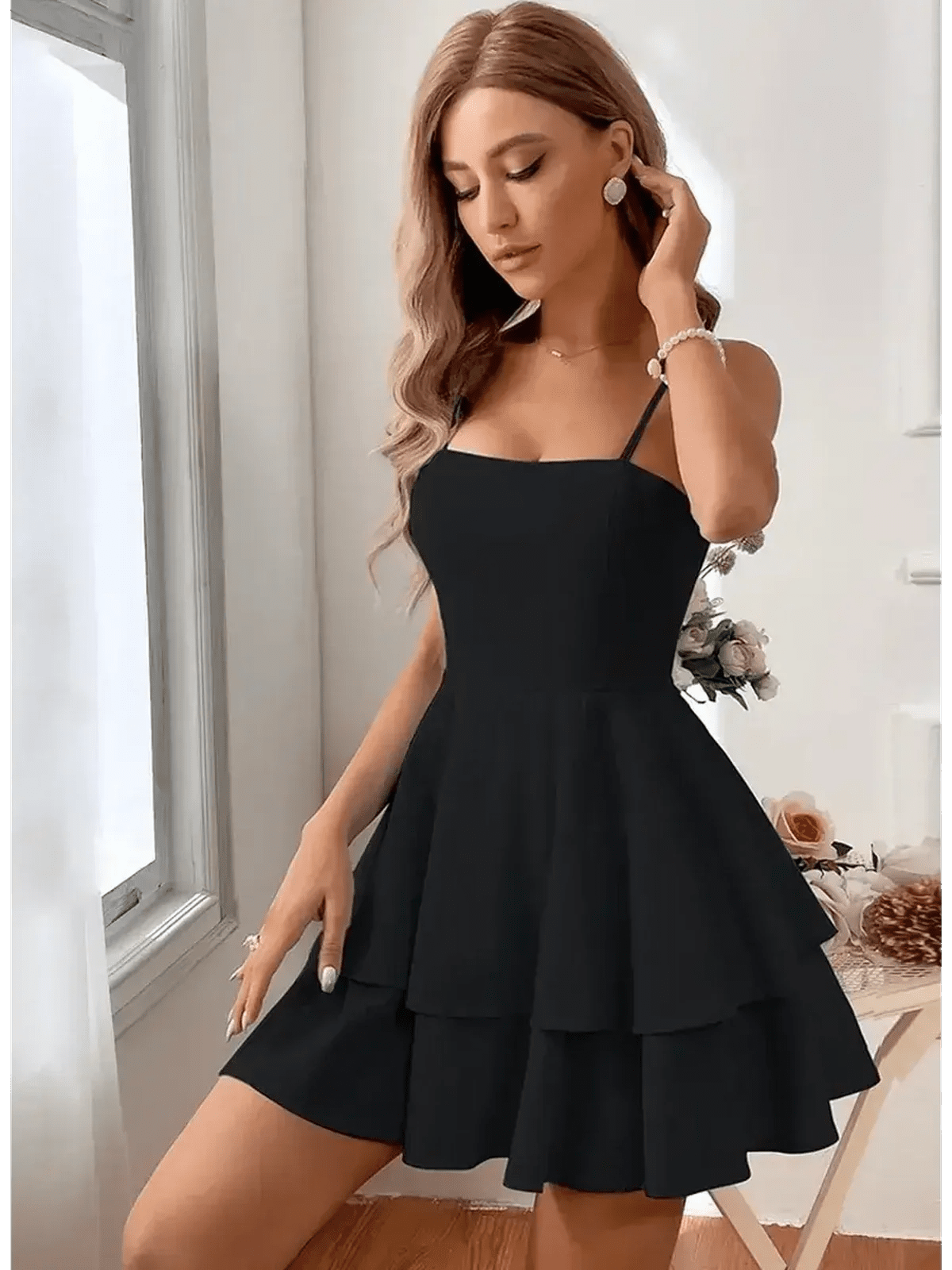 Noir Bloom Mini Dress in black, featuring tiered flounce skirt and adjustable straps, exuding elegance and femininity.